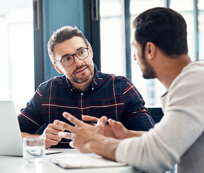 Shot of two businessmen having a discussion in an office